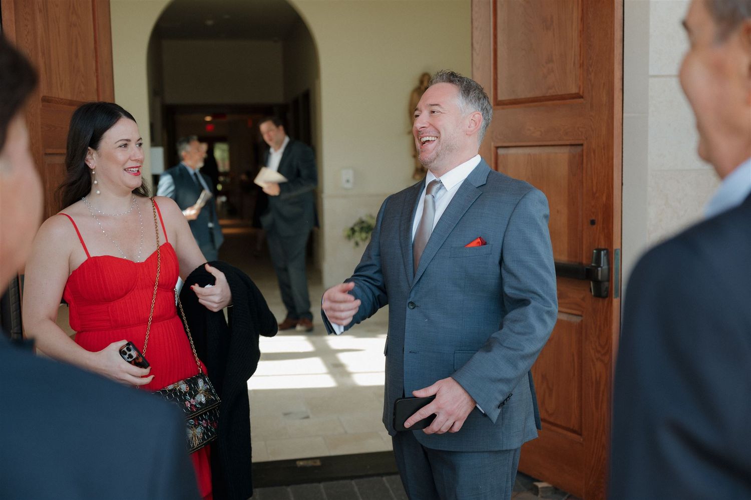 Wedding guests sharing laughter and conversation during the celebration.