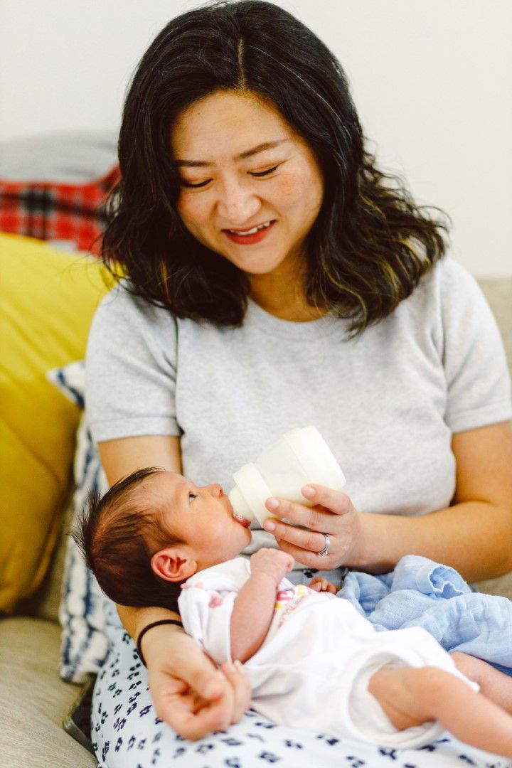 Newborn baby being bottle fed