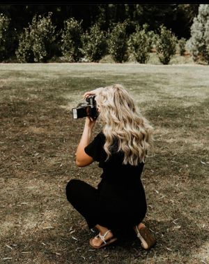 woman kneeling down taking a photo