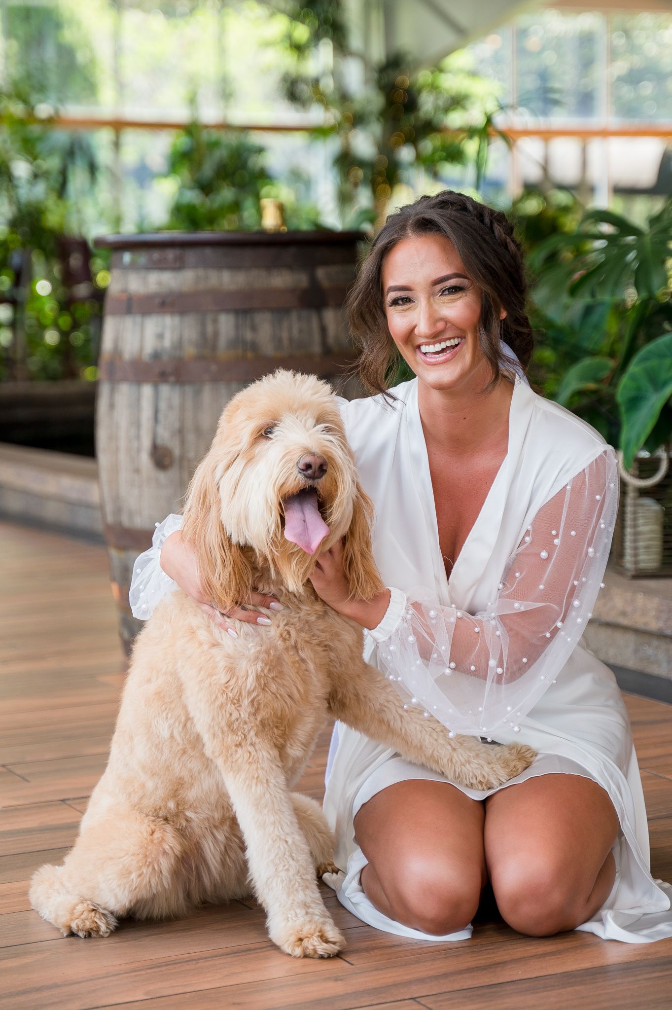 Bride posing with her Labrador dog during the getting-ready portion of her wedding day.