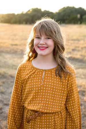Smiling young girl in field in Austin, TX