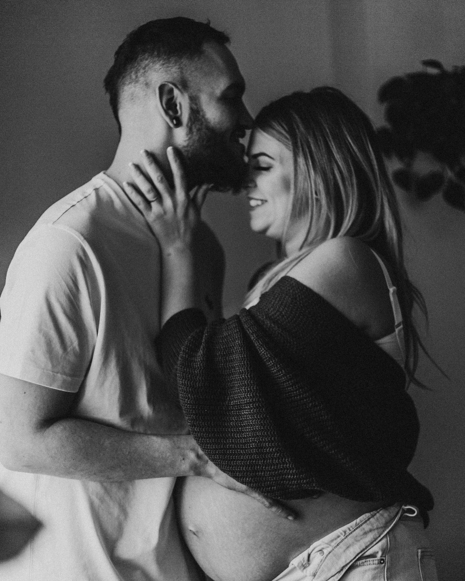 Black and white portrait of loving couple sharing an intimate moment together.