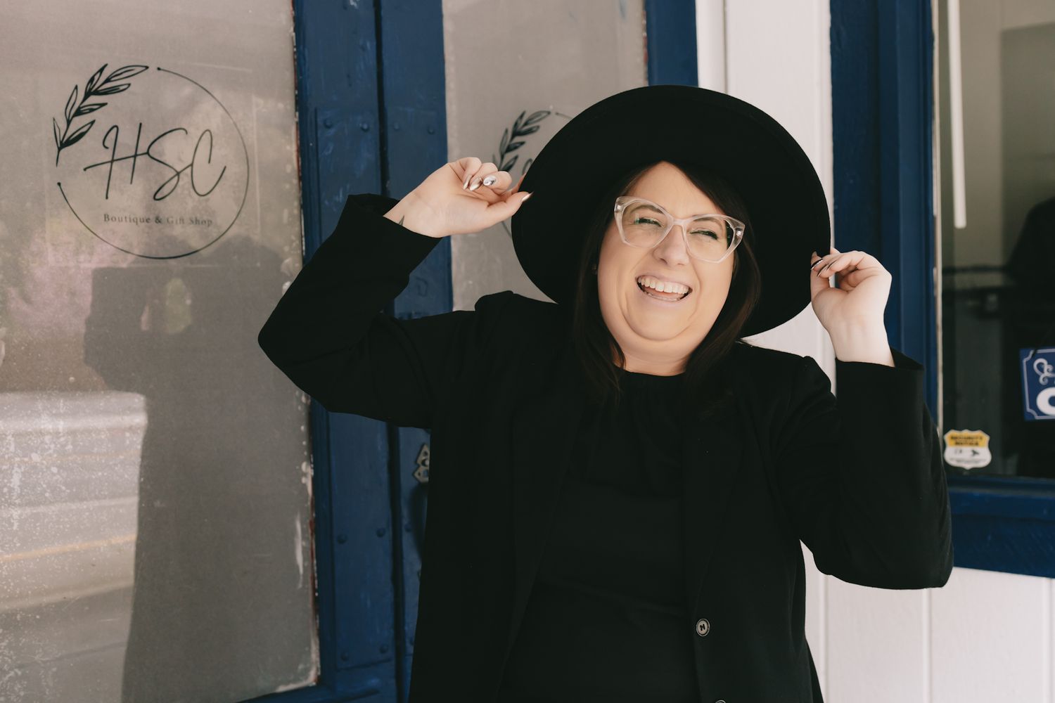 A woman in a black hat smiling