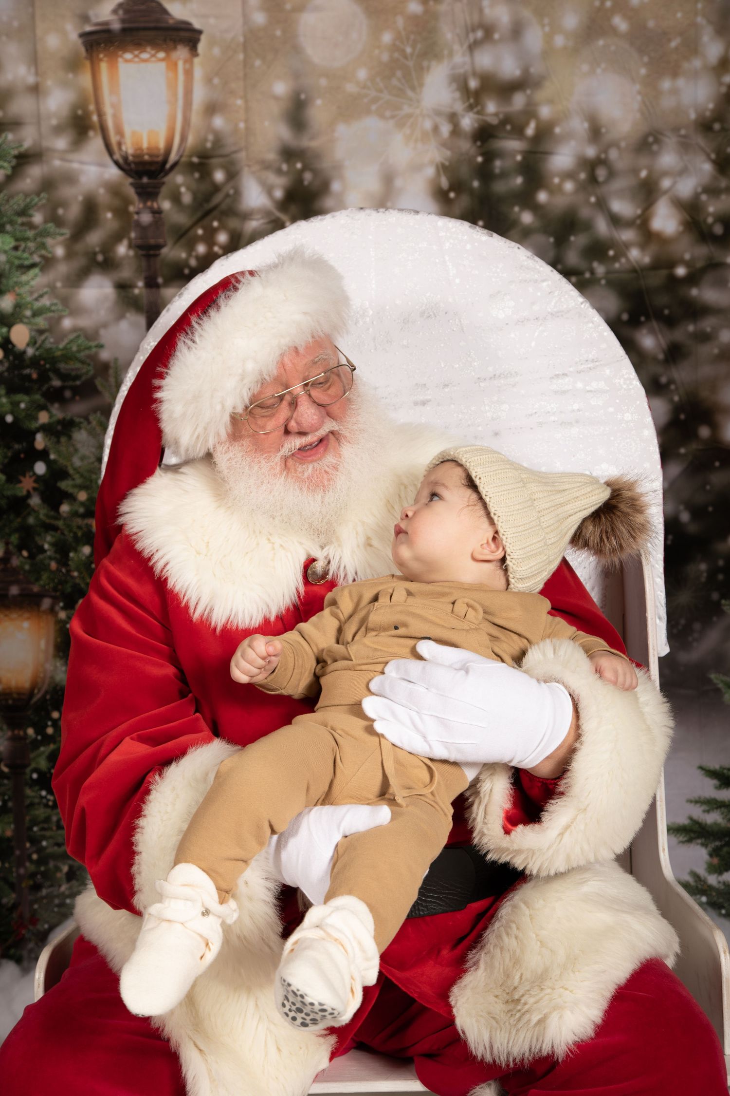 Heartwarming holiday portrait with winter decorations and twinkling lights in background.