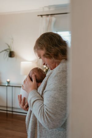 Emotional candid moment between family members in a bright, minimalist interior setting.