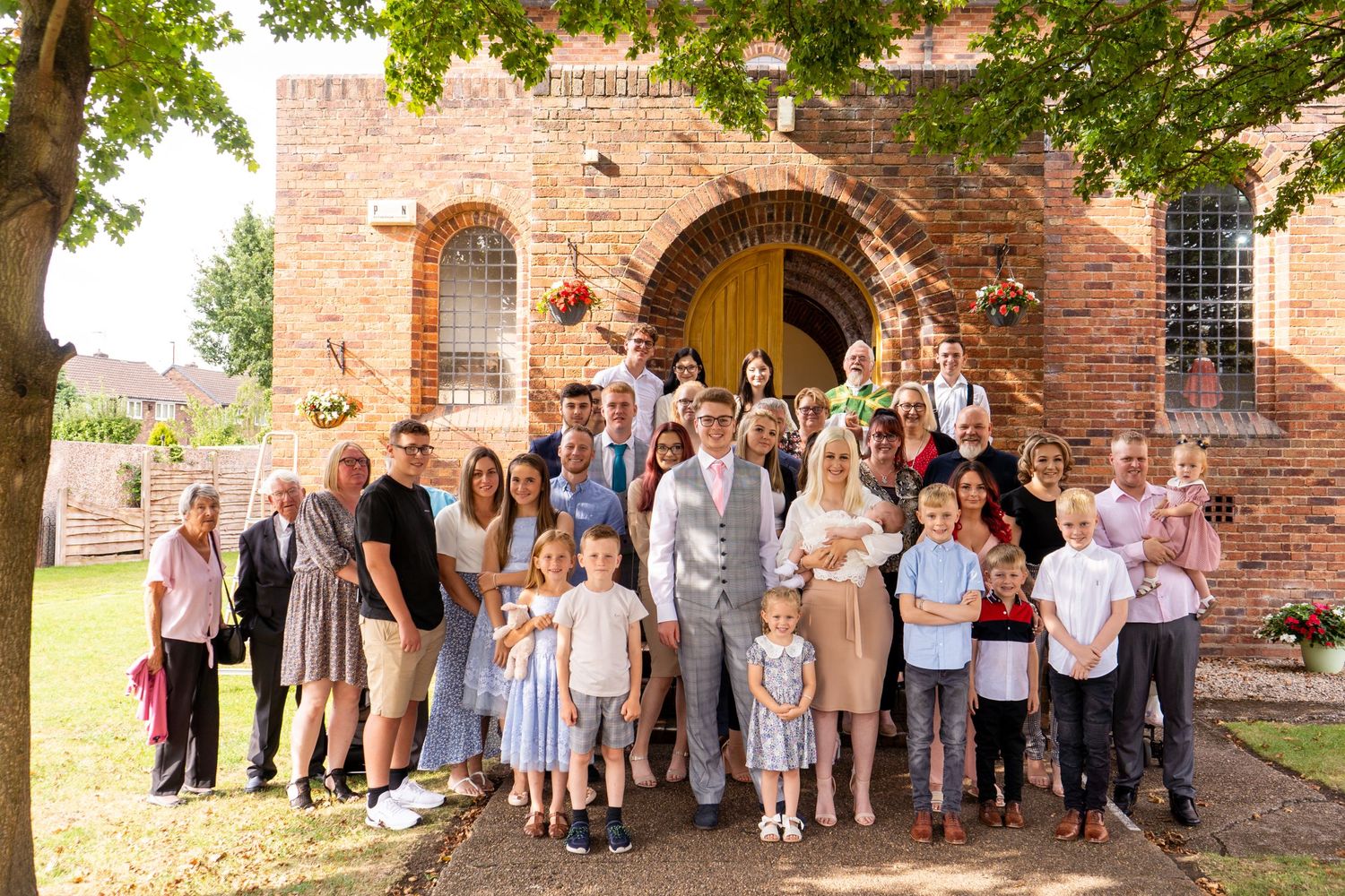 Group photo outside a church at christening with baby by newborn photographer in Doncaster