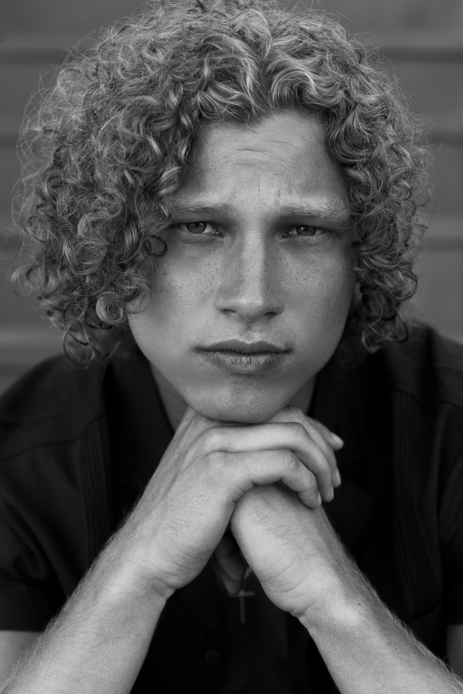 Black and white portrait of curly blonde male editorial model, San Clemente beach fashion editorial