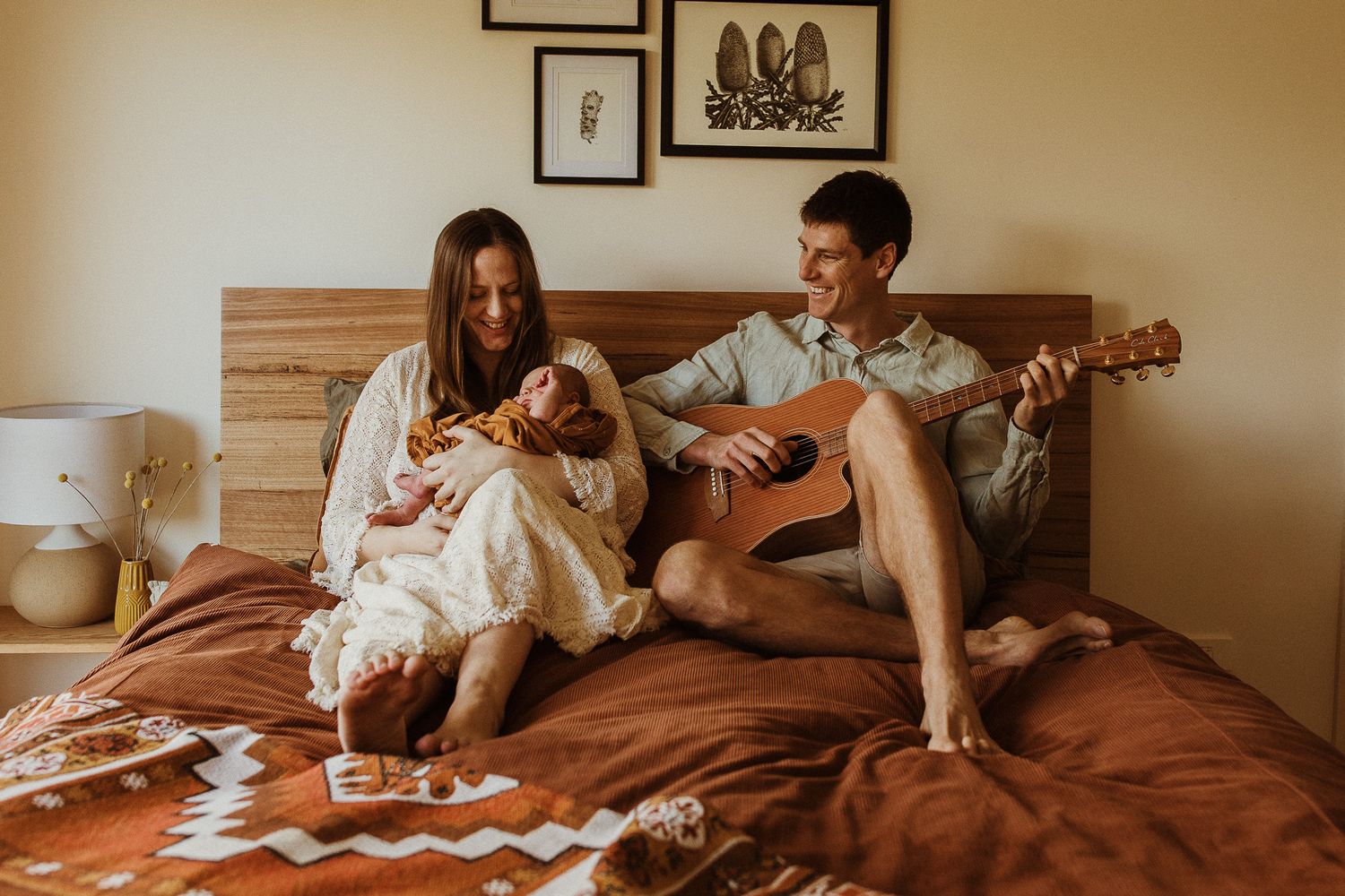 A relaxed bedroom scene with guitar music and white bedding.