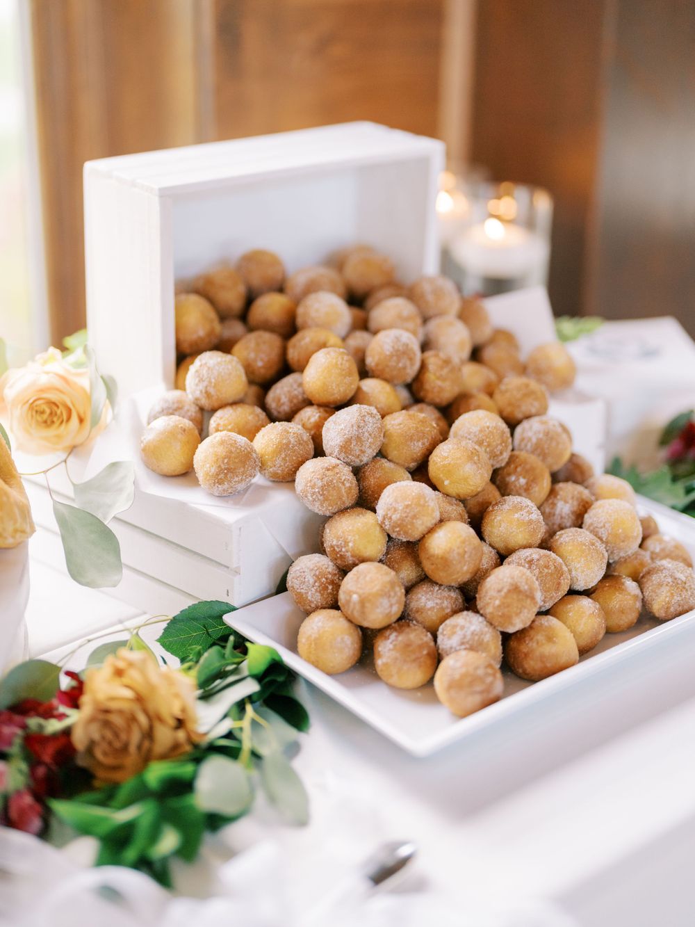 Wedding donut holes for dessert spilled out with natural light. Classic and film-inspired wedding photography in Madison, Wisconsin.