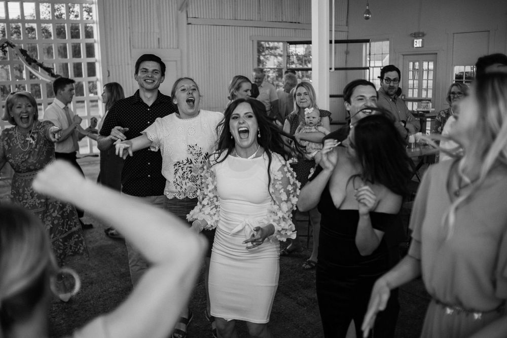 full happy dance floor with bride singing along to song at missouri wedding venue