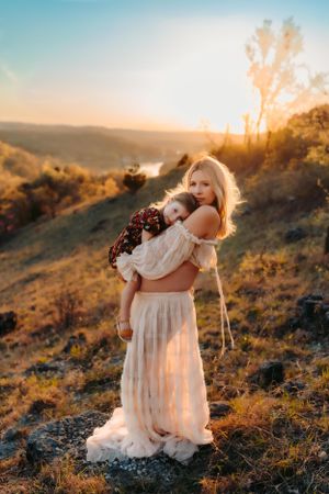 A peaceful moment captured on a hilltop during golden hour with rolling hills in the background.