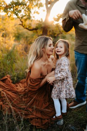Sweet interaction between family members in a scenic fall setting with warm lighting.
