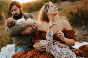 Candid family portrait in autumn with rustic clothing and warm sunset lighting.
