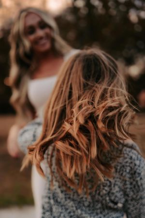 Hair toss captured in warm golden light during sunset photoshoot.