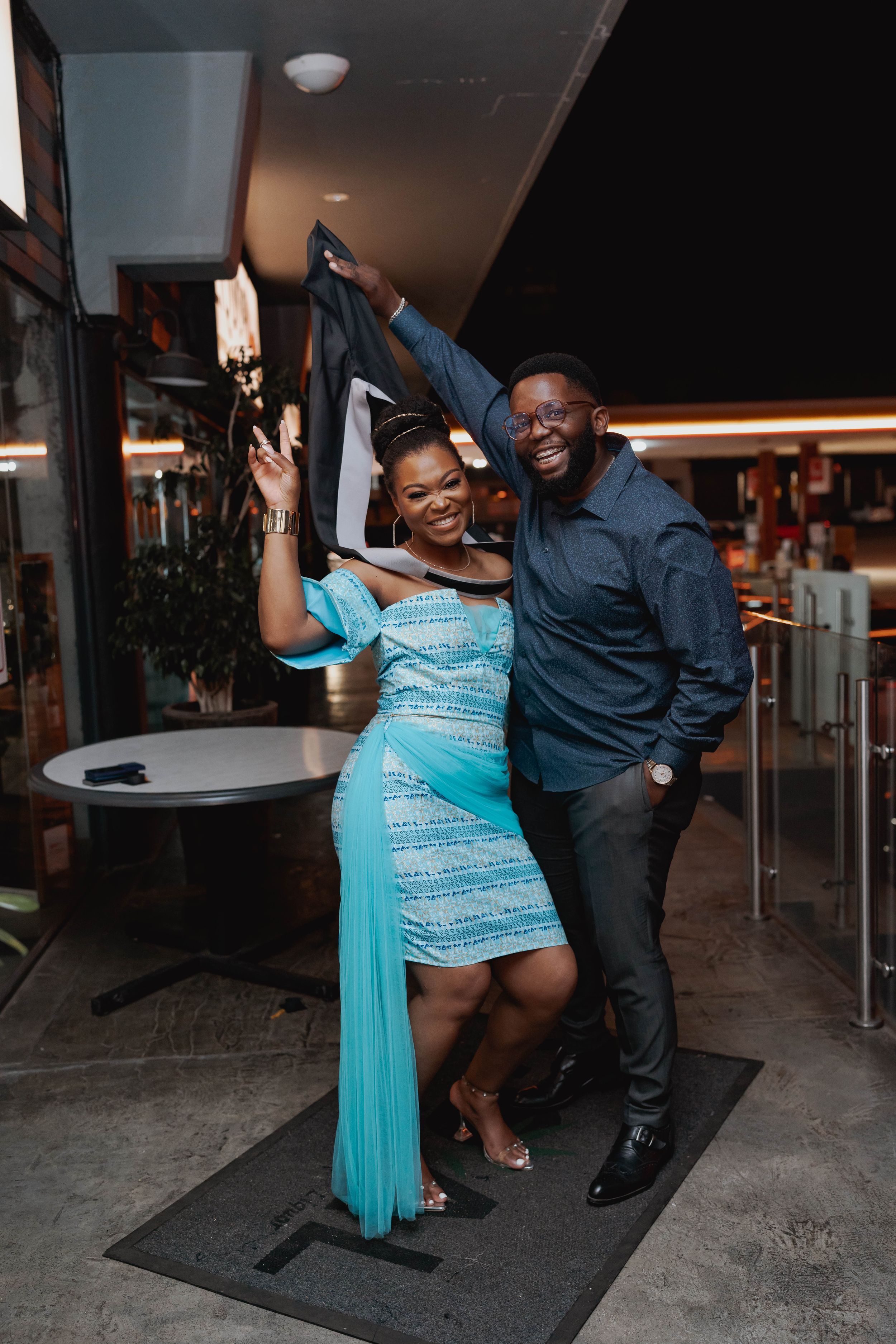 A couple dancing and celebrating at an evening event.