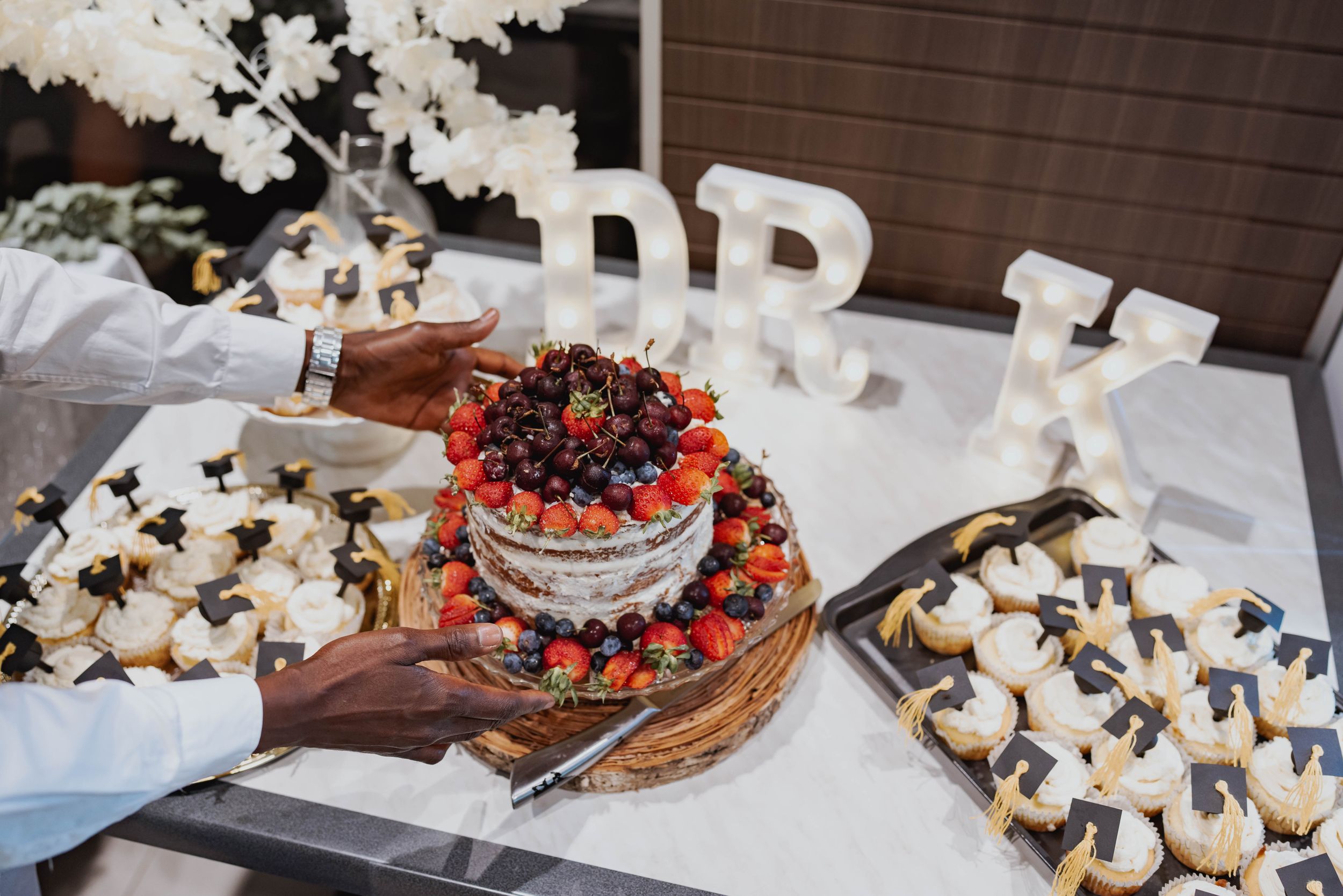 A dessert table with fresh berries and pastries decorated for an elegant event.