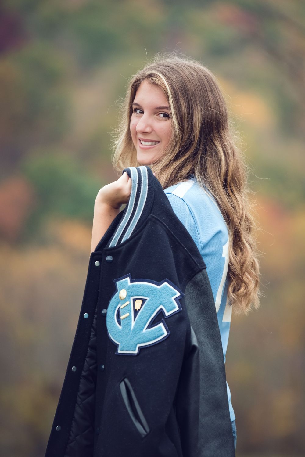 senior girl fall session with letterman jacket