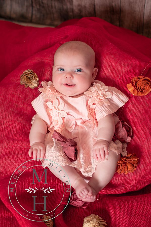 full body image of 4 month old baby girl with flowers