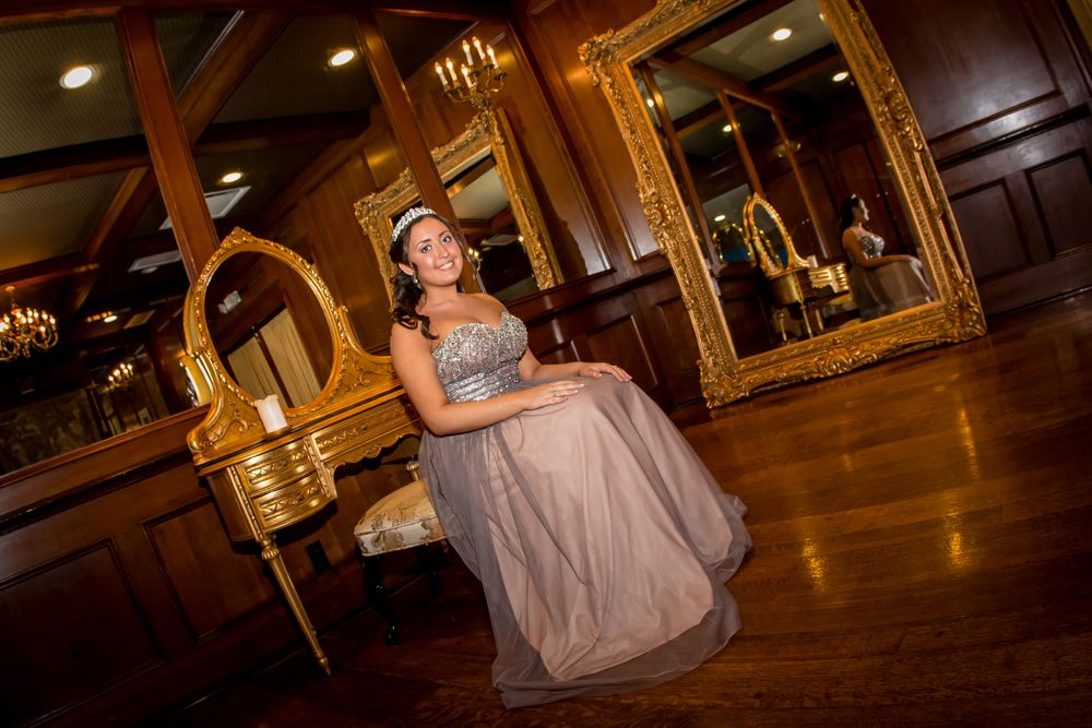 Elegant evening photo in a ballroom with ornate mirrors and wooden details.