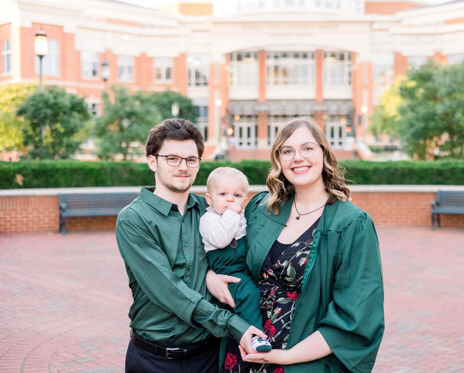 Mom with her husband and son in front of college.