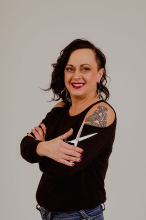 A series of expressive portrait photos showing someone in a black sweater making playful poses with scissors.