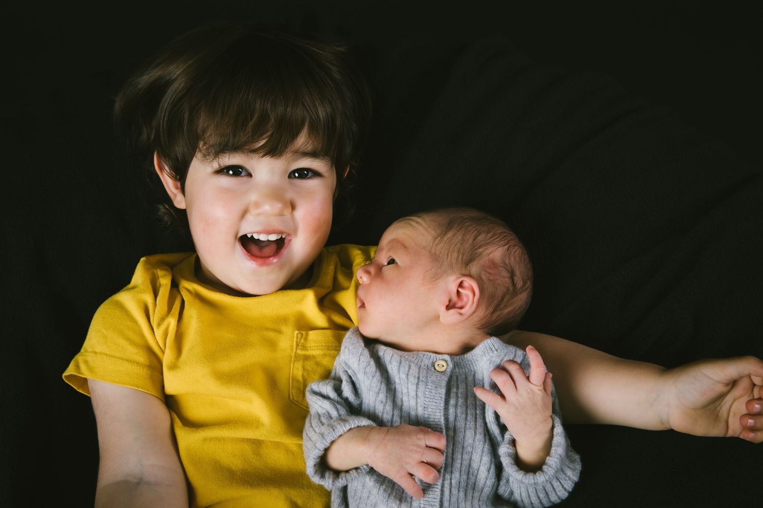 Close-up of two siblings sharing a joyful moment together.