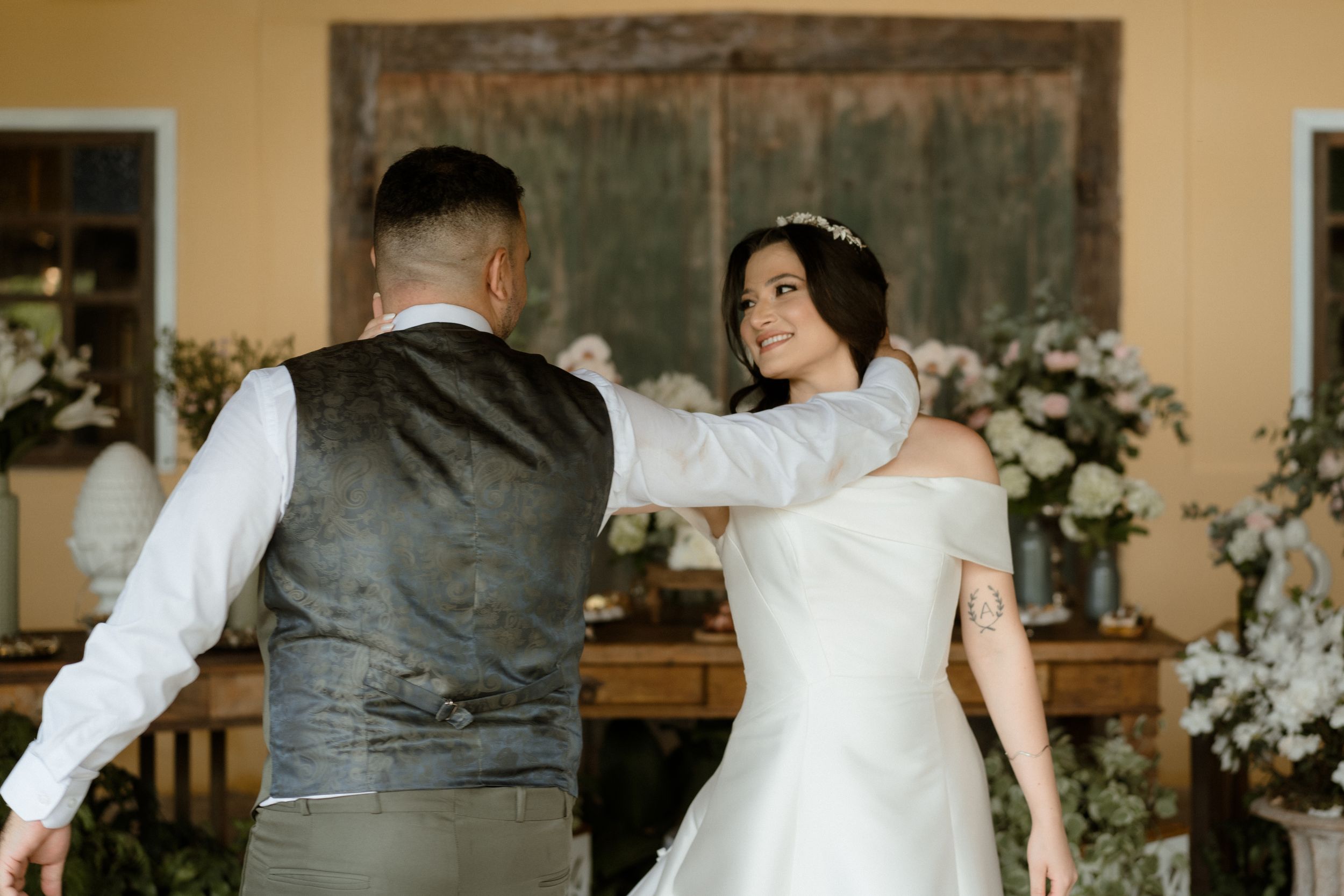 Wedding reception venue decorated with floral arrangements and rustic elements.