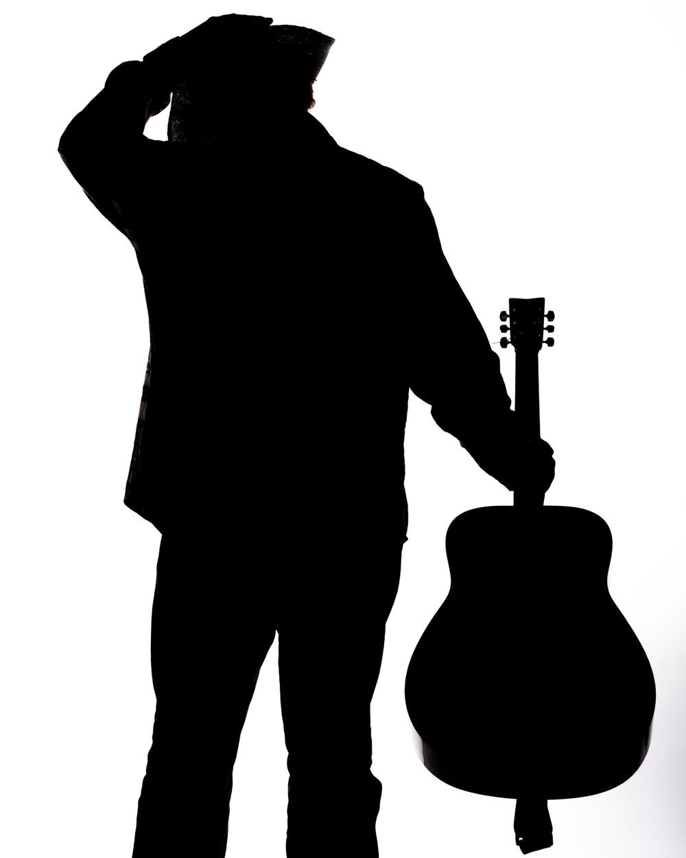 Silhouette of cowboy with guitar