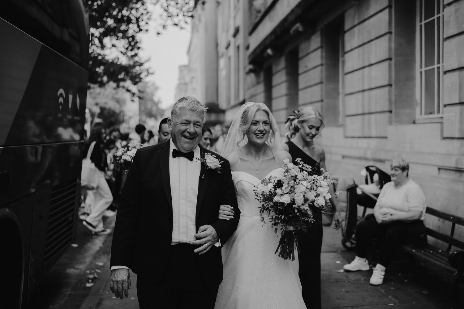 bride and dad walking down busy street on their way to Ashmolean Museum in oxford