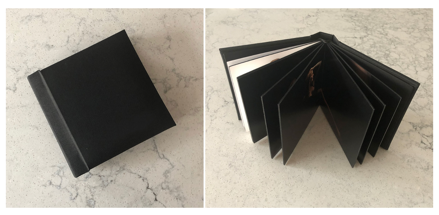 Black photography album samples displayed on a light gray surface showing different layouts and sizes.