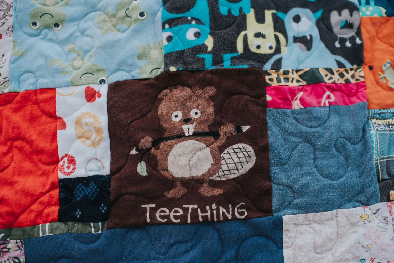 Super cute patch on a memory quilt of a beaver with the words teething on it.