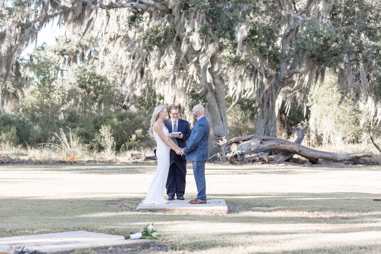 bride and groom say their vows with a preacher