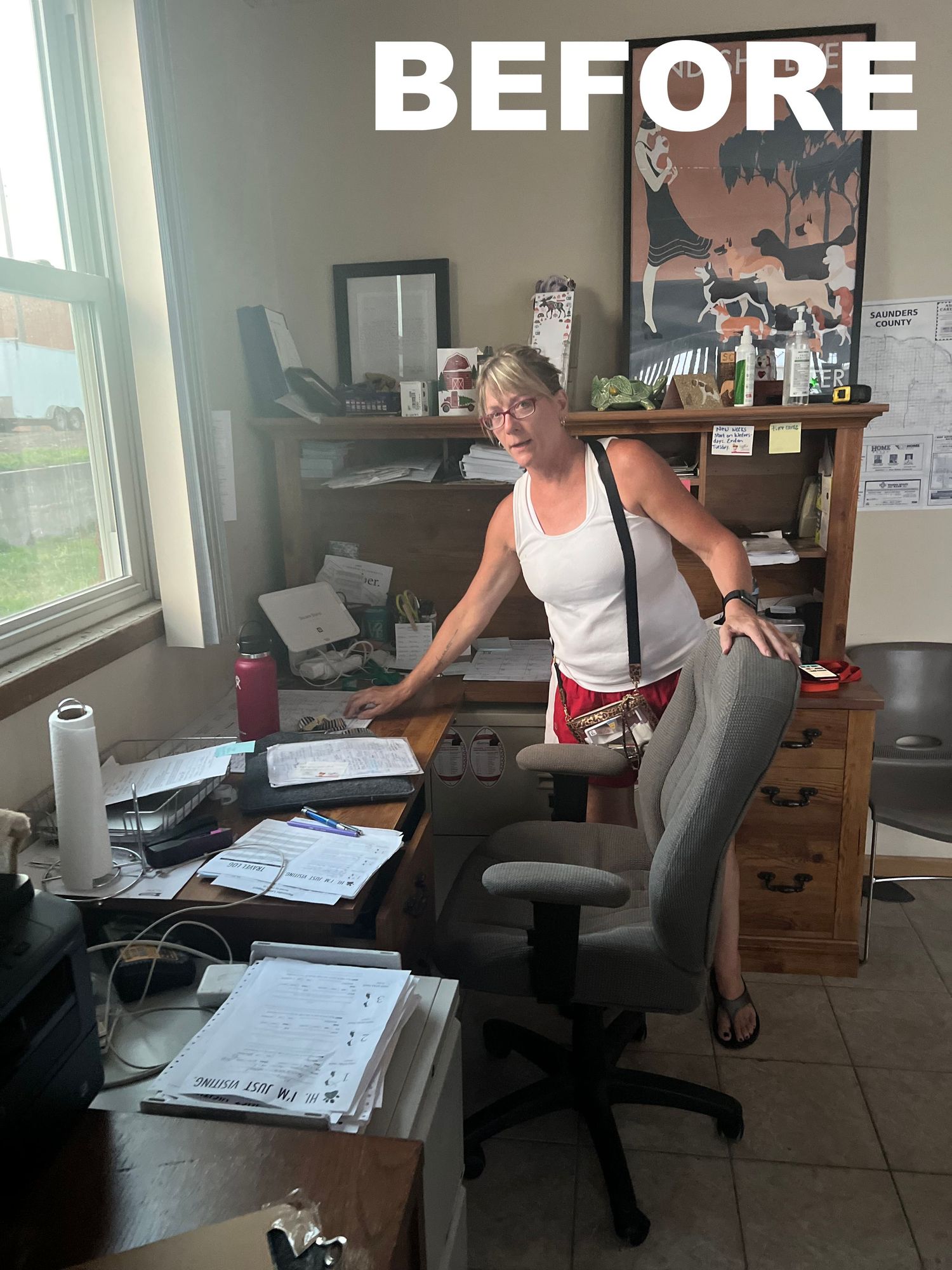 Office workspace with papers and documents spread across desks before organization.