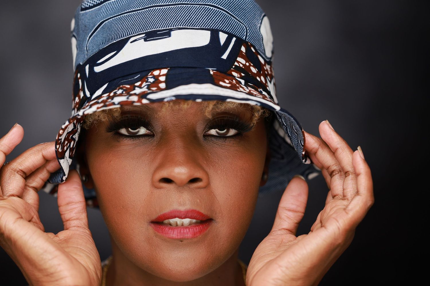 Product Photography with a model wearing a patterned bucket hat .
