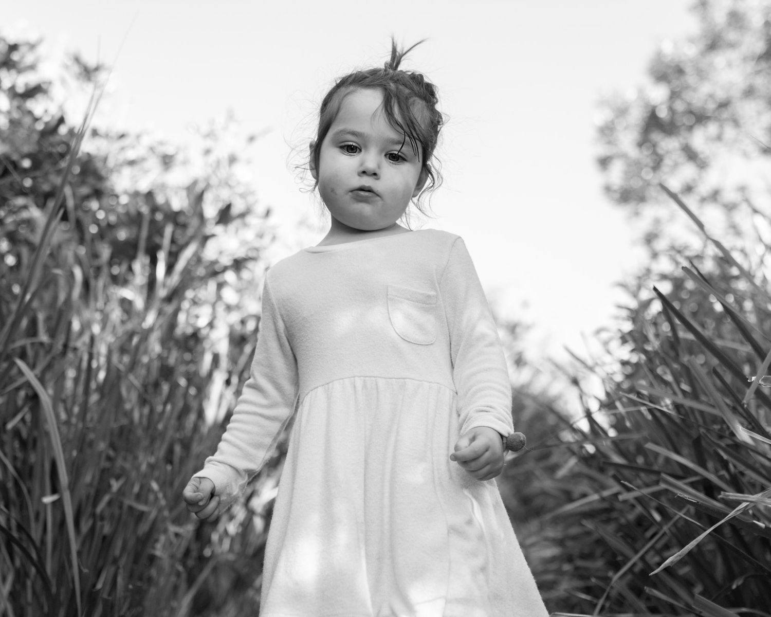 Isla looking sad at the beach in long sleeved dress