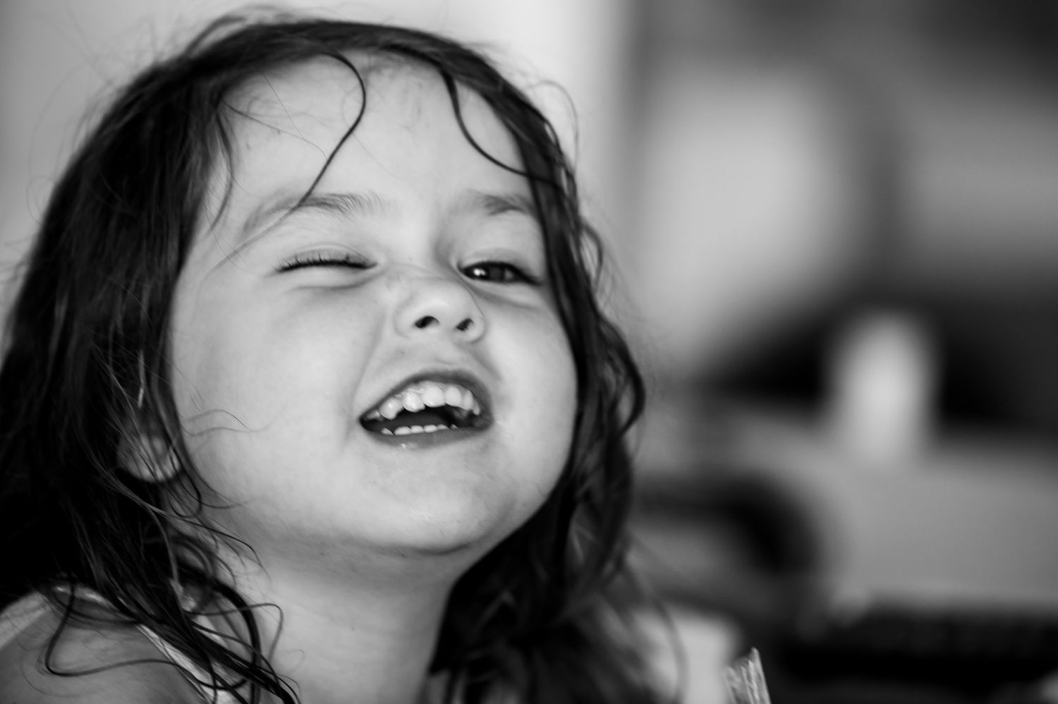 black and white of toddler winking at camera