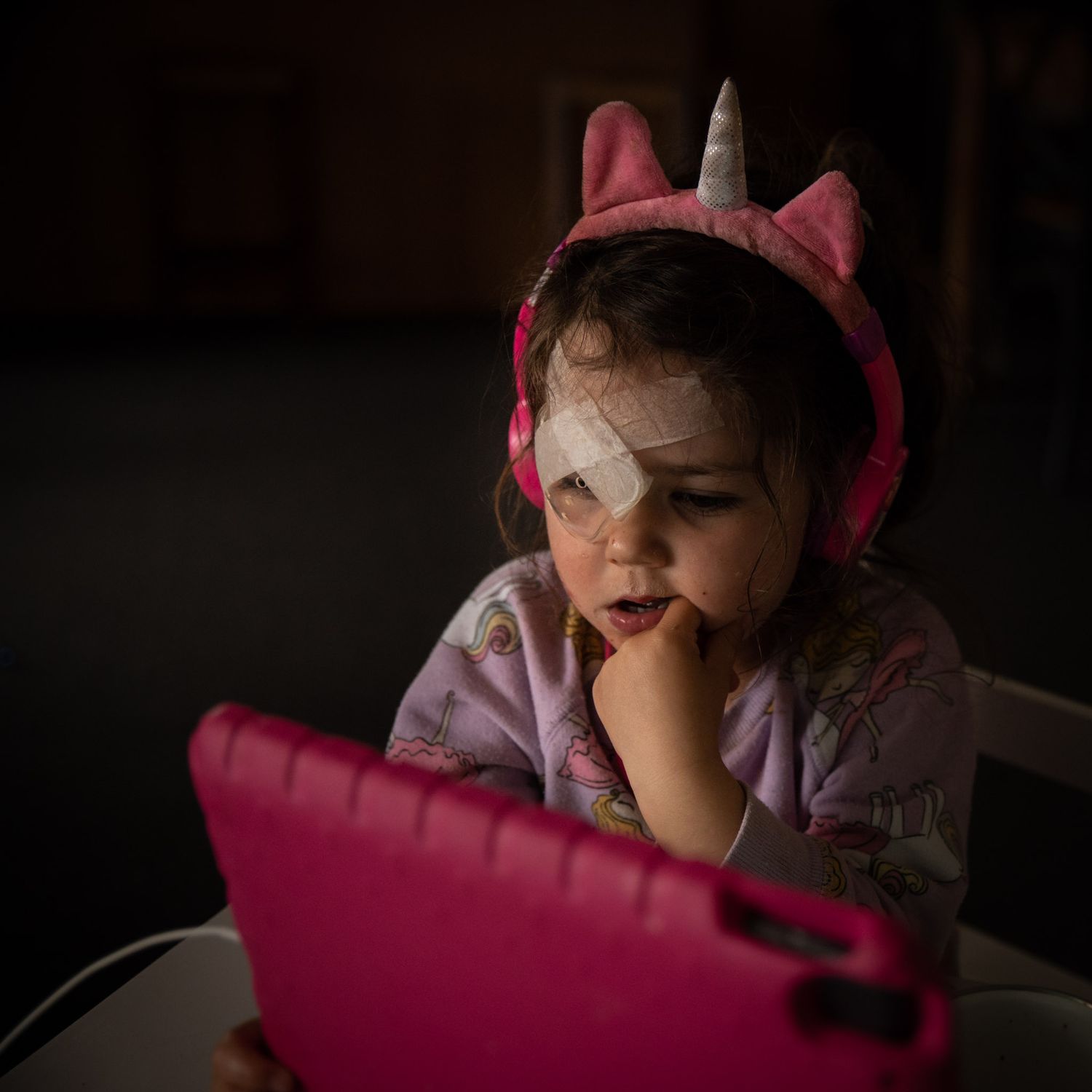 Young girl on iPad with patch over eye