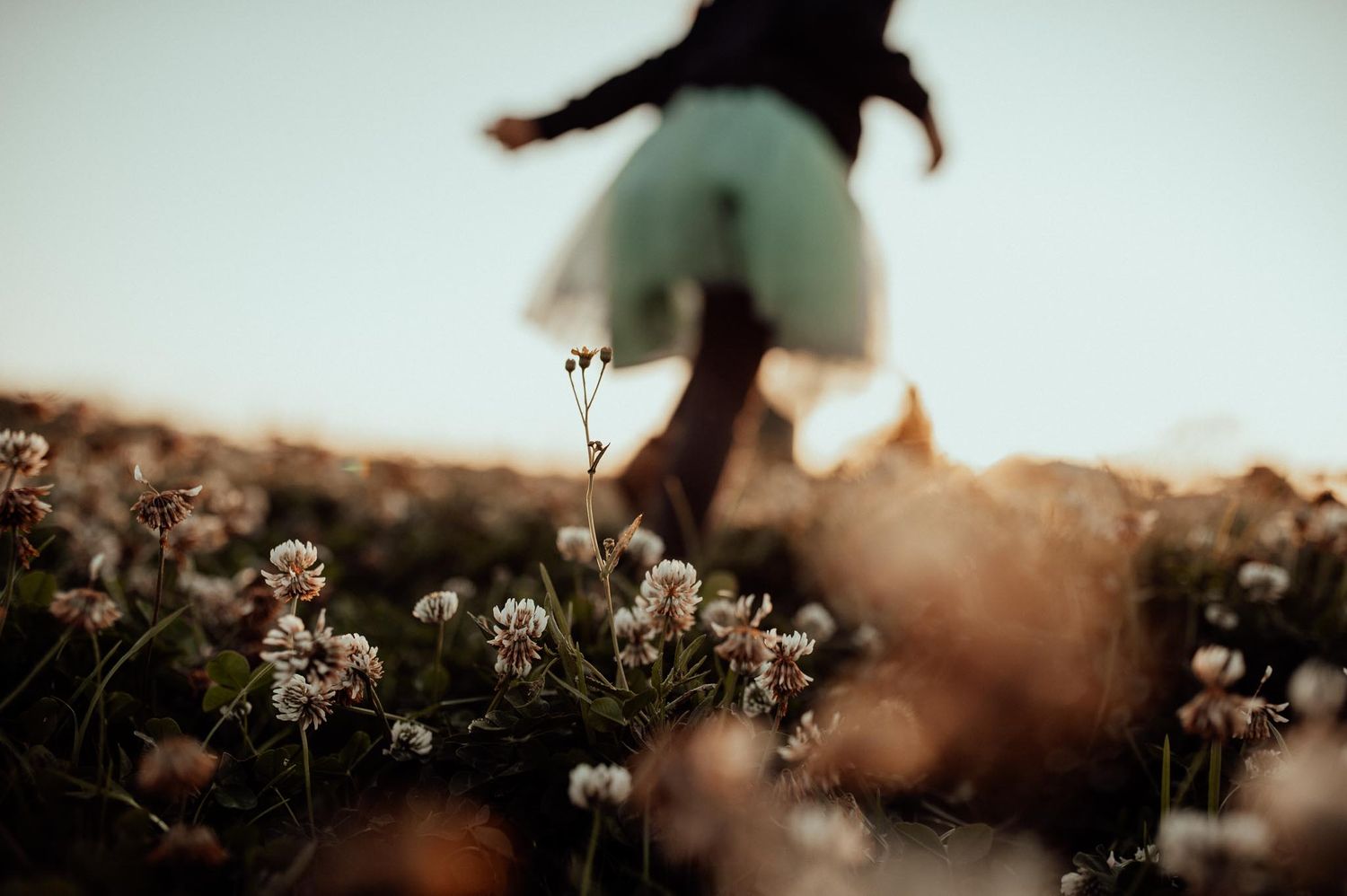 Flower field with young girl running