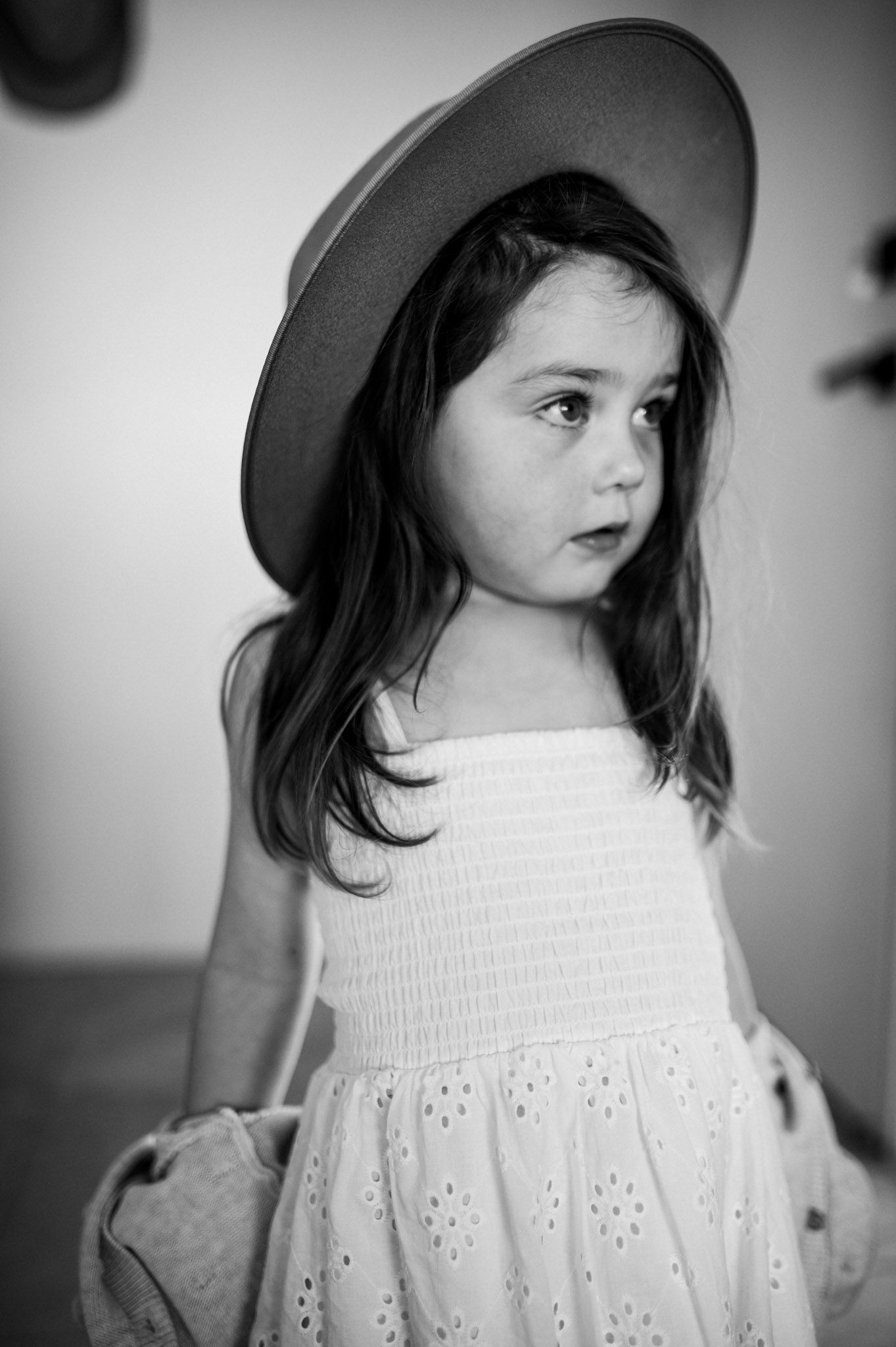 Girl in cute cowboy hat and white dress