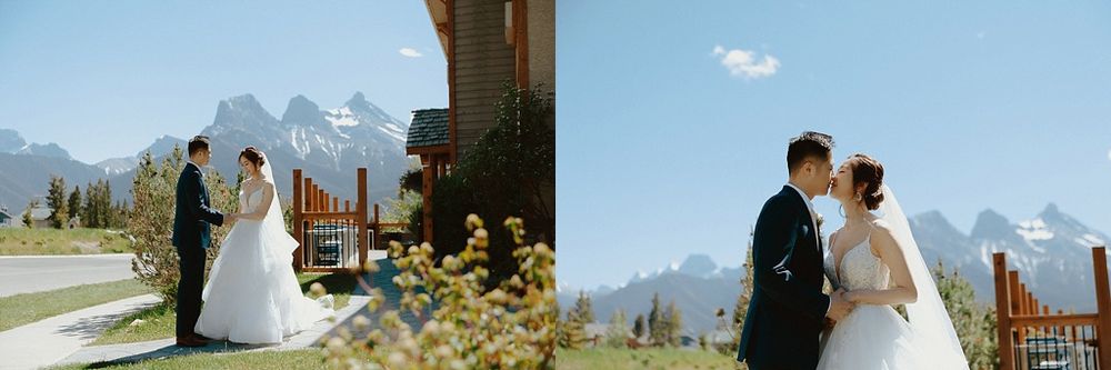 An outdoor wedding portrait with dramatic mountain peaks and natural scenery in the background.