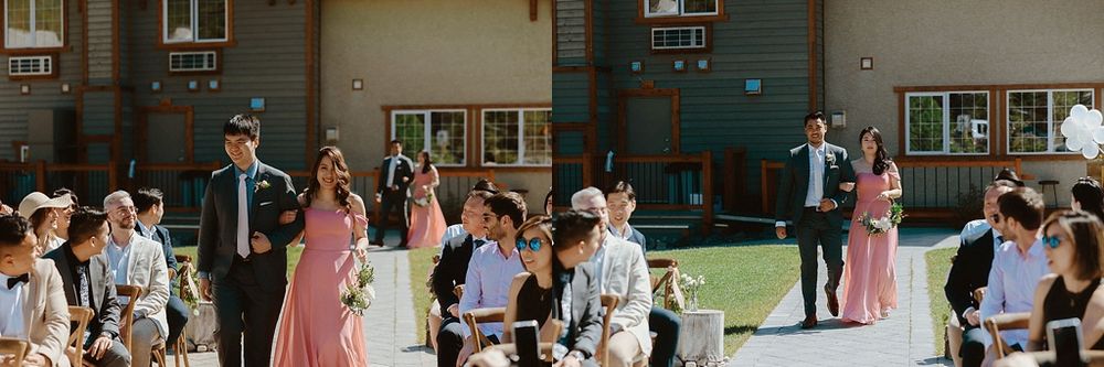 Wedding guests seated in wooden chairs at an outdoor mountain venue.