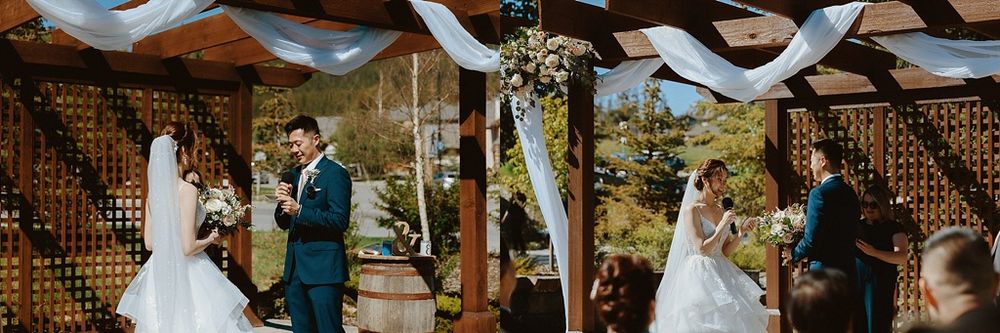 Wedding ceremony under wooden pergola decorated with white fabric draping.