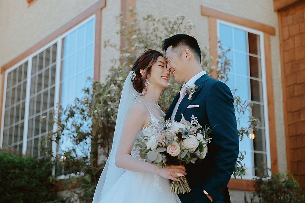 Intimate wedding moments captured on rustic wooden deck with mountain views.