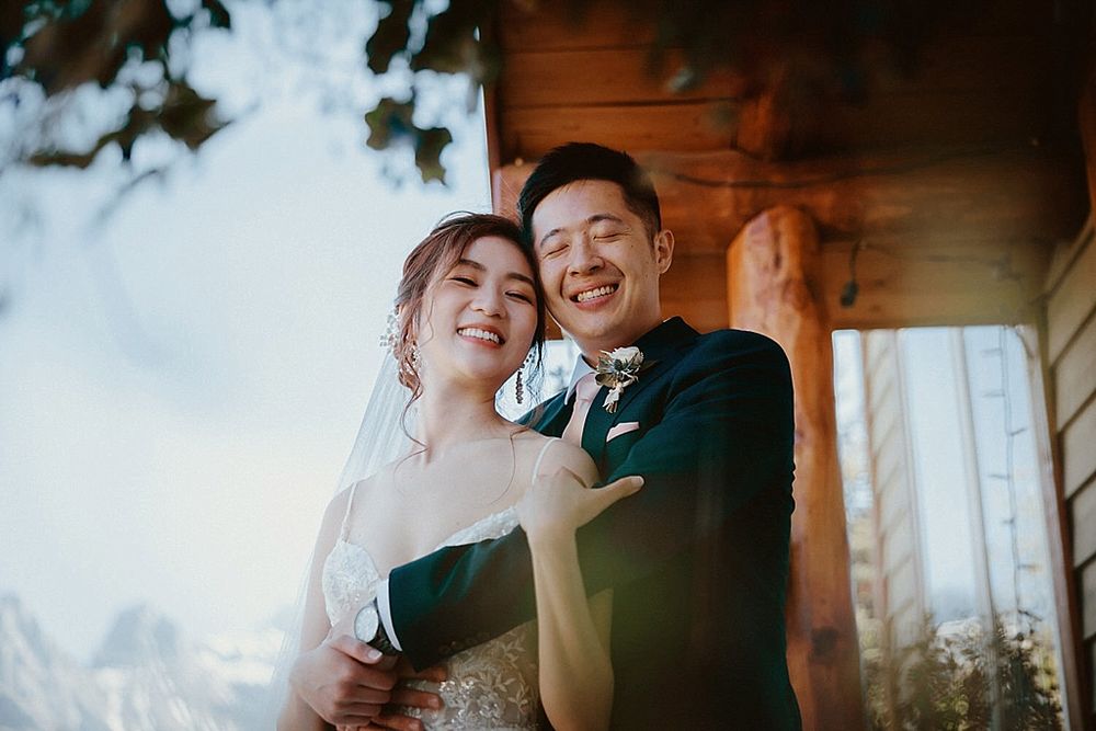 Romantic sunset wedding photos inside rustic mountain lodge.
