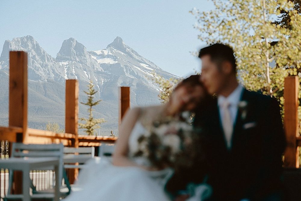 Panoramic mountain vista behind wooden lodge wedding venue.