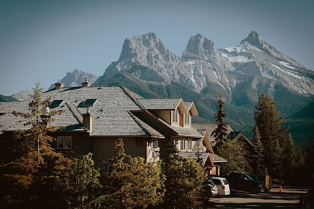 Panoramic view of mountain peaks and chalets in a scenic mountain resort setting.