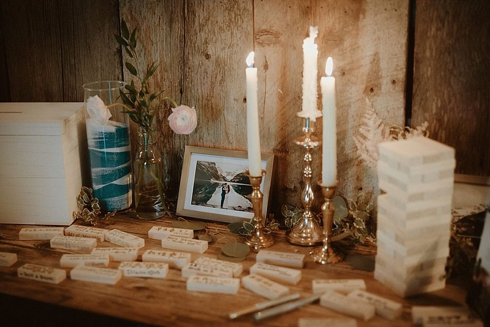 Rustic wedding decor featuring glowing candles and vintage elements on wooden surfaces.