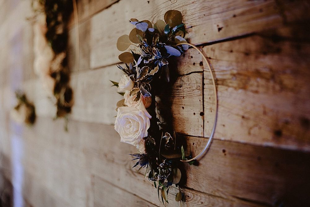 Floral decorations and rustic design elements mounted on wooden wall panels.