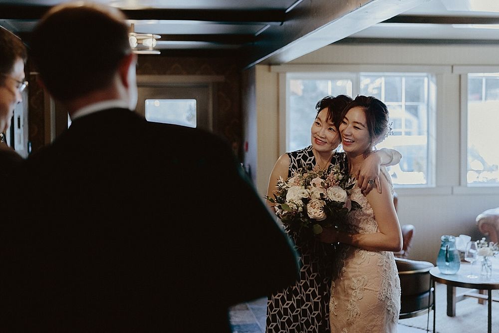 Wedding reception guests enjoying festivities in a dimly lit venue with elegant decor.
