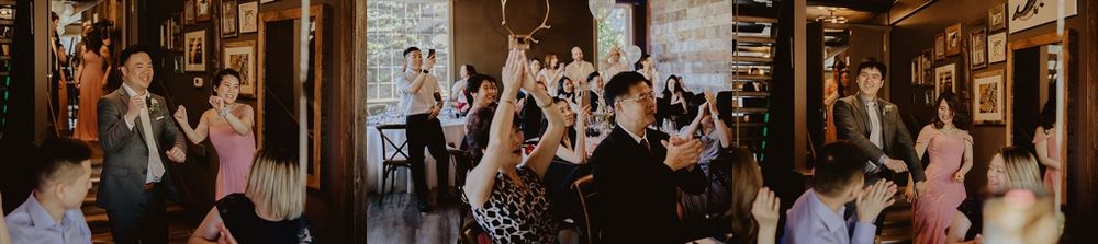 Festive wedding reception scene with guests celebrating in a rustic indoor space.